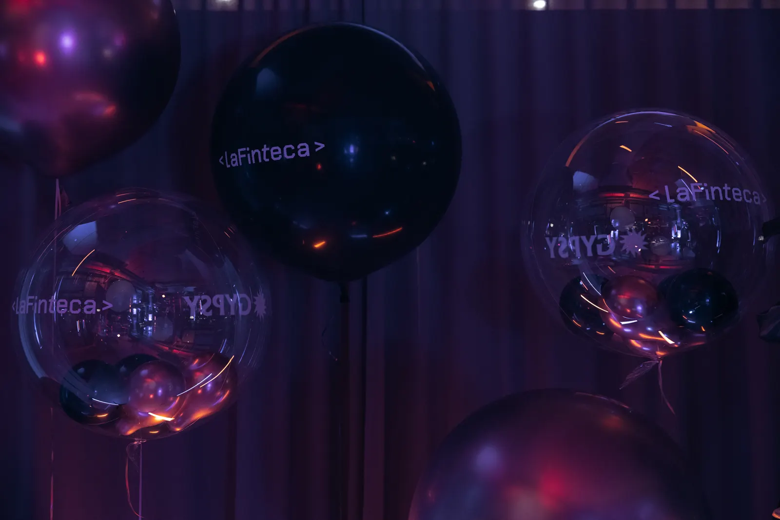 Balloons printed with the LaFinteca wordmark at a team celebration