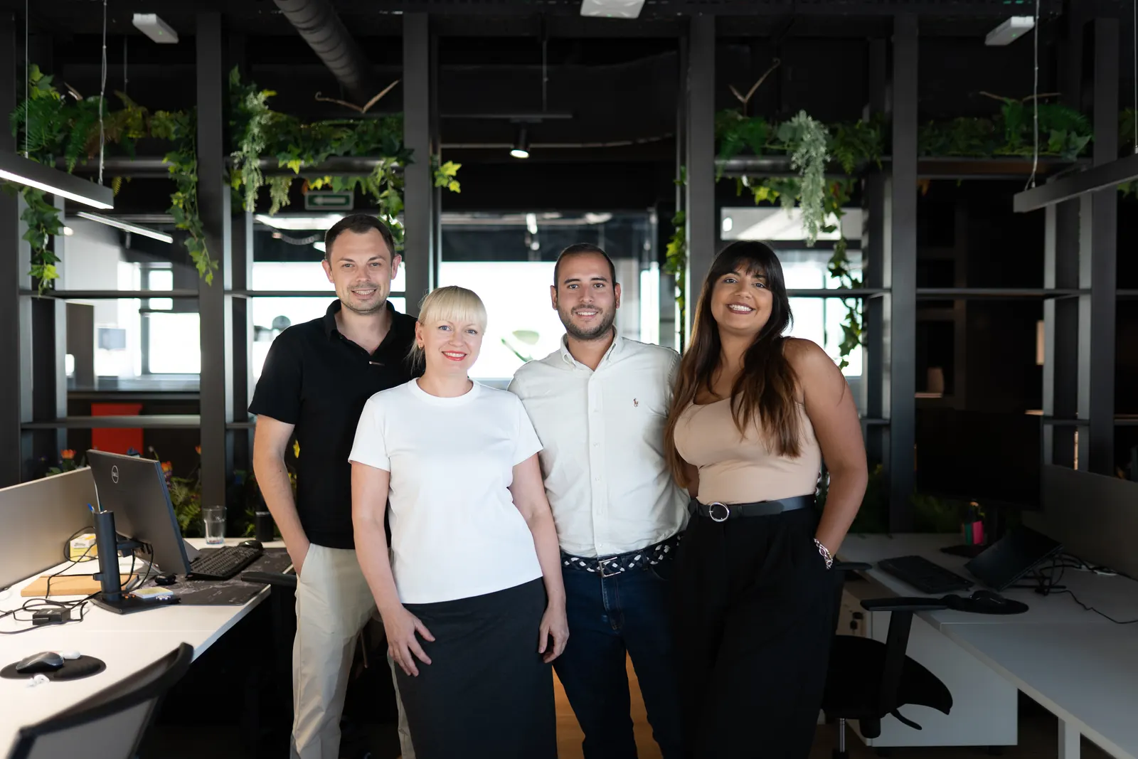 Four LaFinteca team members standing together in the office